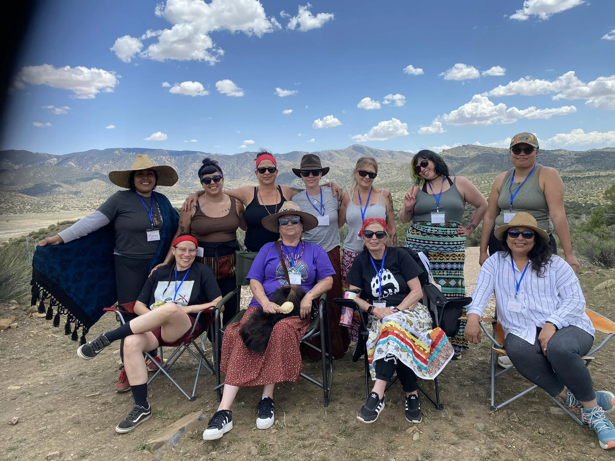 A retreat circle gathered outdoors for ceremony and community.