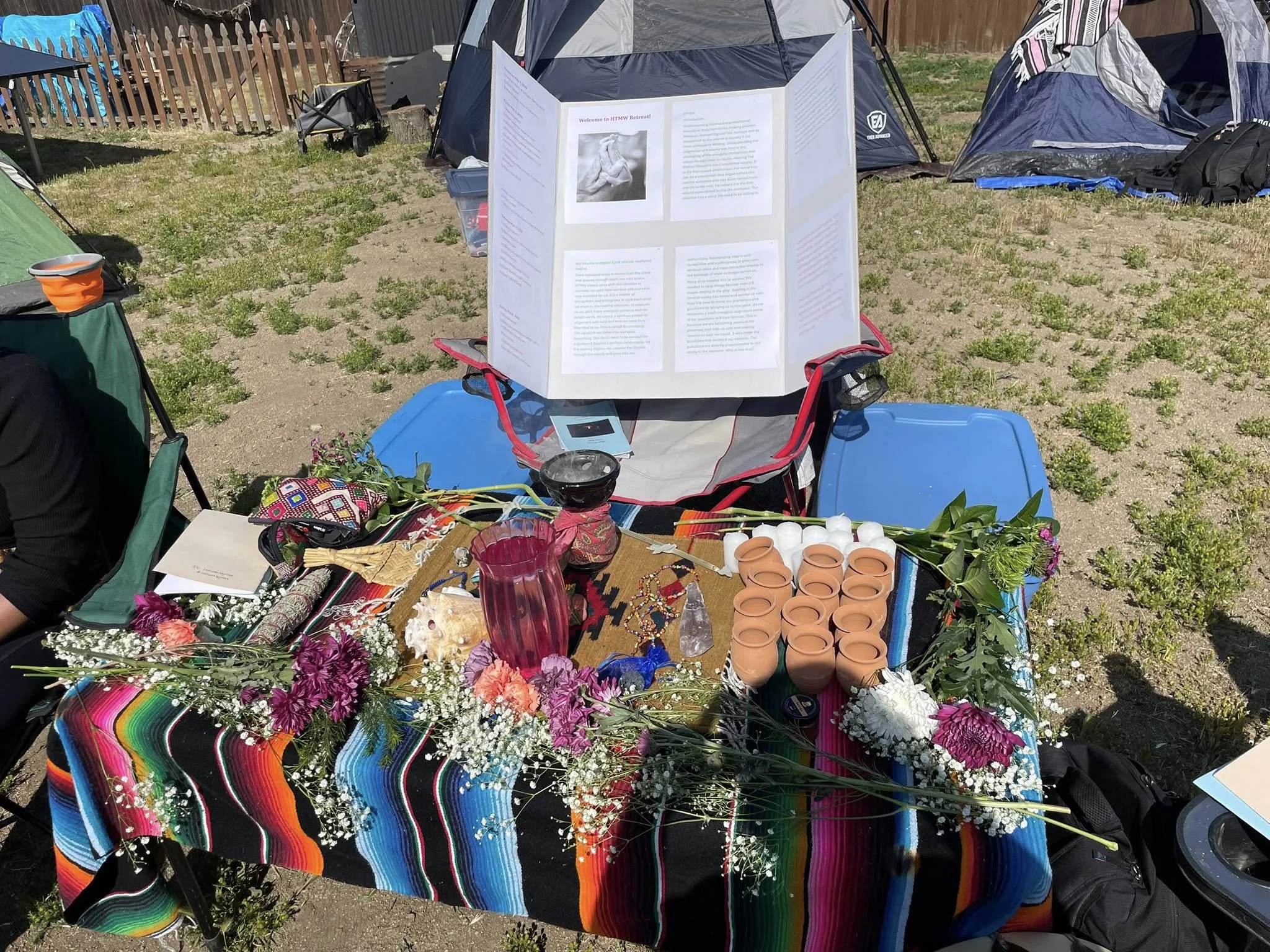 Community gathered outdoors in a retreat circle for ceremony and connection.